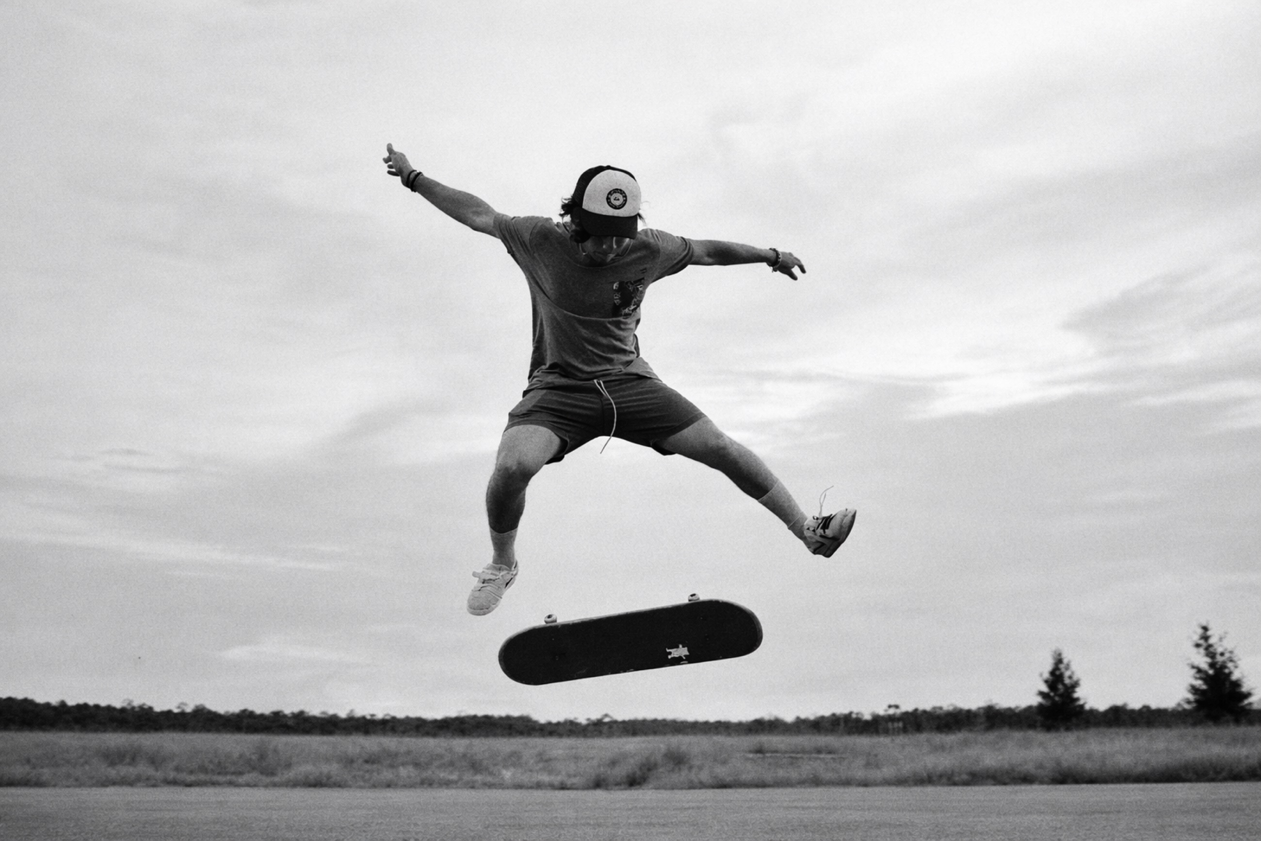 Matteo Merriam — skateboarder mid-air, black and white